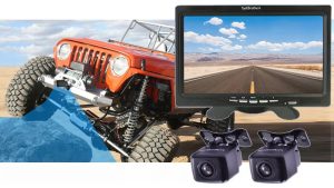 Backup camera kit featuring two black mounting cameras and a widescreen monitor displaying a desert highway rear view, shown alongside an off-road Jeep in a rugged landscape.
