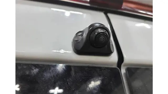 Small round backup camera mounted on vehicle